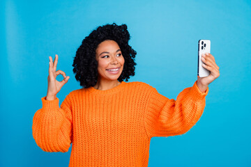 Photo portrait of lovely young lady hold telephone take selfie v-sign wear trendy knitwear orange...