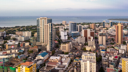 Cityscape of Dar es Salaam at sunset featuring residential and office buildings.