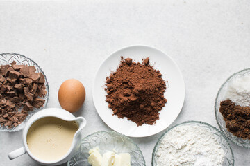 Obraz na płótnie Canvas mise en place for making chocolate muffins, Flatlay of ingredients for making chocolate muffins, ingredients for making chocolate muffins