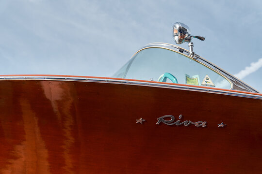 Monaco, Monte Carlo, 29 September 2022 - the wooden side of the luxury motor boat Riva in port of Hercules, sunny glare of the sun, elegance boat, glossy surfaces shine in sunny weather