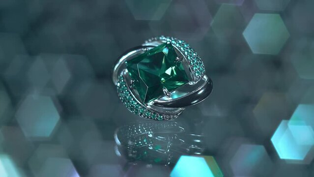 A silver earring with an emerald and a scattering of small precious stones sparkles in the light against a beautiful blurred background. Closeup. Macro. Shallow depth of field. Shot in motion