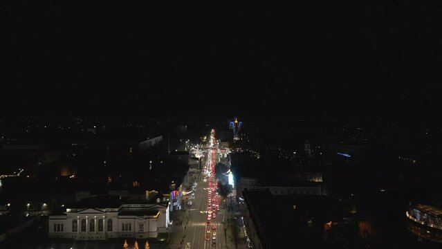 Aerial Drone Night view of Christmas, Winter Festival of Chisinau in City Center. Christmas Tree, Government House of Moldova, The Great National Assembly Square, Road. Republic of Moldova 4K