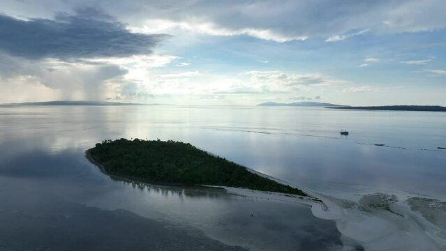 Early morning light illuminates the remote island of Koon near Seram, Indonesia. This scenic island's coral reefs, and the surrounding seas, support extraordinary marine biodiversity.