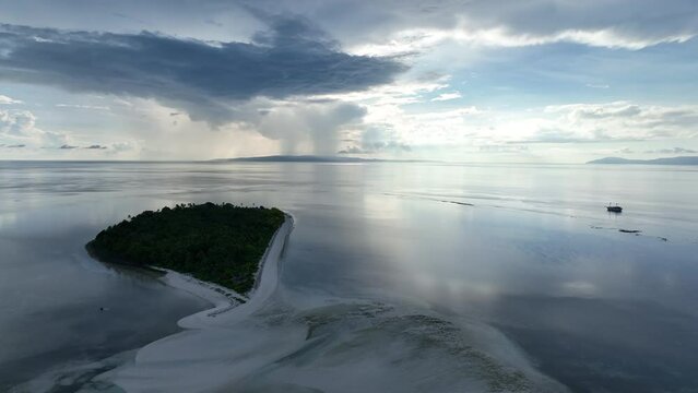 Early morning light illuminates the remote island of Koon near Seram, Indonesia. This scenic island's coral reefs, and the surrounding seas, support extraordinary marine biodiversity.