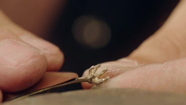 Close-up of Jeweler Using Grinder to Polish Gold Ring