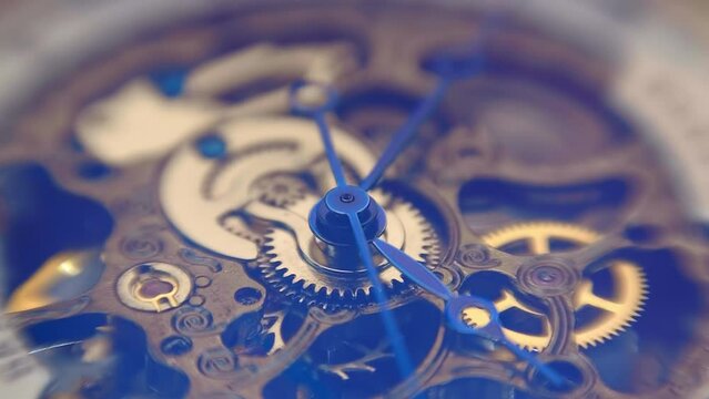Beautiful internal structure of a skeleton wristwatch where shiny gears, wheels and hands move with sparkling bokeh. Closeup. Macro. Shallow depth of field