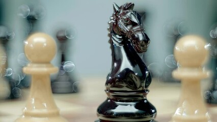 A woman's hand with beautiful blue nails with sparkles that glitter in the light moves a horse on a chessboard during a chess competition. Closeup. Macro. Shallow depth of field. Follow focus