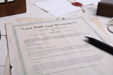 Last will and testament with pen on white wooden table, closeup