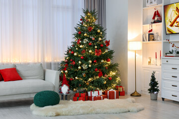 Beautiful Christmas tree, gift boxes and festive decor in living room. Interior design
