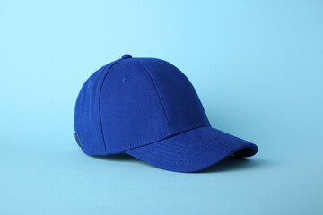 Stylish baseball cap on light blue background