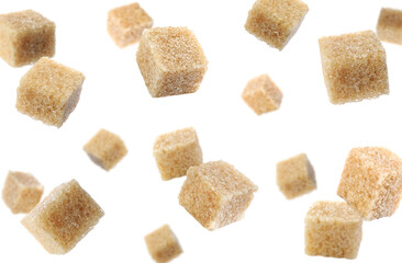 Cubes of brown sugar falling on white background