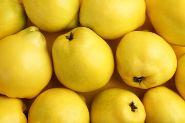 Delicious ripe quinces as background, top view