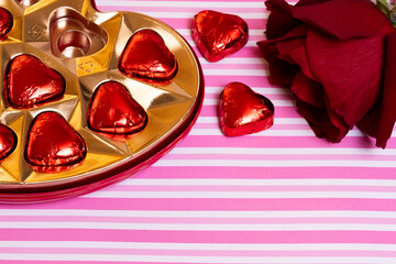box of chocolates and rose valentines day pink and white background