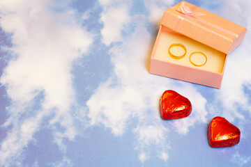 valentines day chocolates and rings in a box on a sky background pattern-2