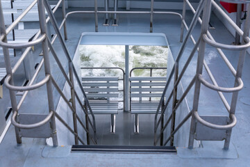 Photograph of stairs leading from the top deck on a tour boat in Milford Sound in Fiordland...