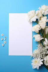 A bouquet of flowers next to a blank paper on a blue background