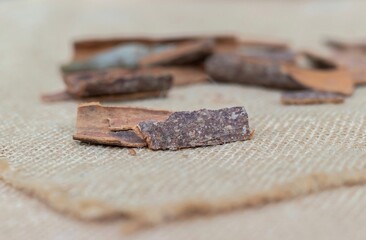 Closeup of Cinnamon Bark Spices in Isolated on Burlap Fabric in Horizontal Orienation