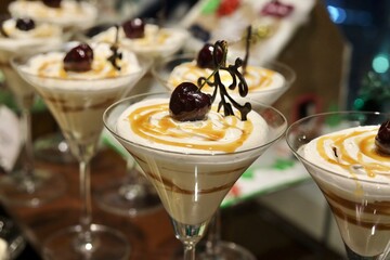 Butterscotch milkshake with cherry and caramel in a glass with beautiful Christmas decoration 