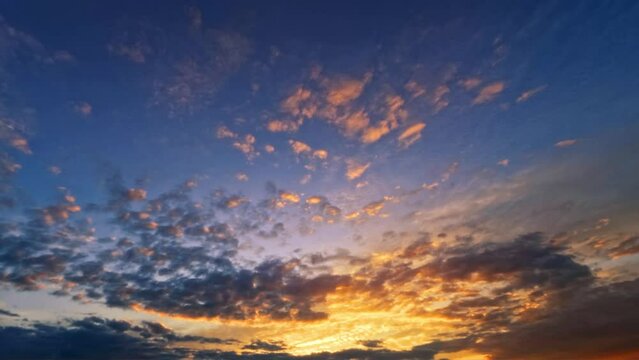 timelapse - goldish sunrise scene with fluffy clouds - loop video