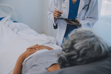 Women Asian doctors hold the patient hand and encourage and provide medical advice While checking...