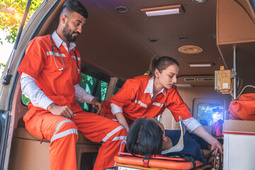 Female rescue workers, nurses and emergency medical personnel save the lives of injured people,...