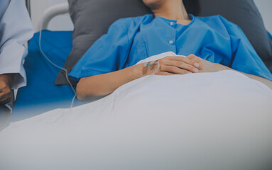 Asian Doctor make routine health check with patient in hospital ward