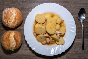 Potato soup with chicken and bread rolls