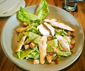Chicken Caesar Salad on wooden table