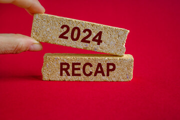 2024 RECAP symbol. Concept red words 2024 RECAP on brick blocks. Beautiful red background....