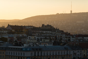 Golden hour view of Budapest buildings and hills