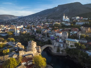 Wall murals Stari Most Stari Most, river and surrounding village and mountain