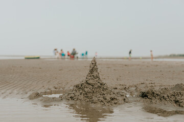 Drip sand castle on the sandbar in summer