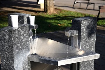 Decorative drinking fountain for spa guests in the summer on the square