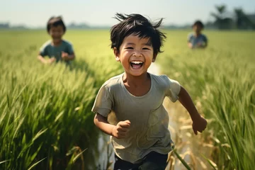 Foto op Canvas Asian child runs in the paddy field. Generative AI. © visoot