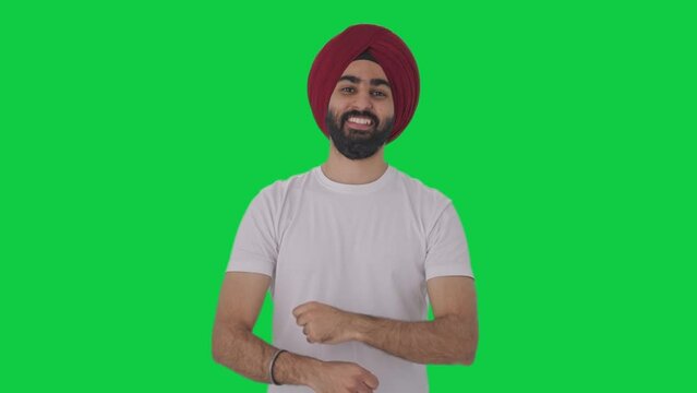 Happy Sikh Indian man dancing and doing Bhangra Green screen