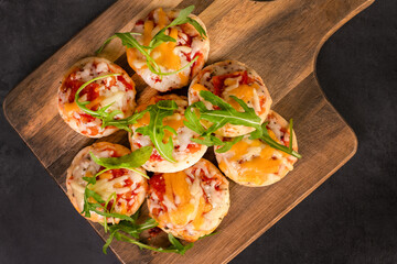 Mini pizza party snacks on a wooden board
