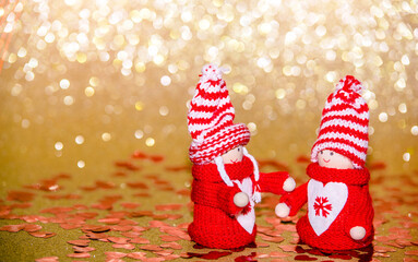 Christmas toys stand on a shiny gold background
