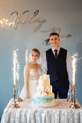Bride and groom cutting and tasting wedding cake