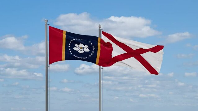 Alabama and Mississippi US state flags waving together on cloudy sky, endless seamless loop