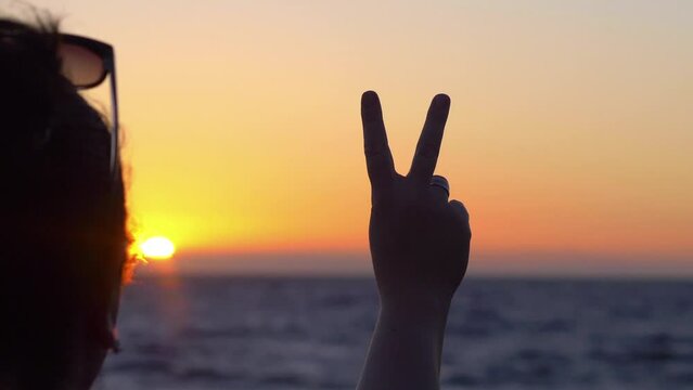 Make peace not war sign at the sunset in 4k slow motion 60fps