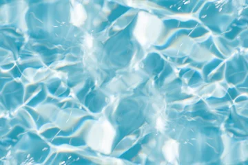 Küchenrückwand glas motiv Bluewater waves on the surface ripples blurred. Defocus blurred transparent blue colored clear calm water surface texture with splash and bubbles. Water waves with shining pattern texture background. © Water 💧 Shining 📸