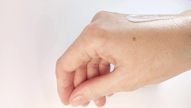 Hand cream. Woman applying cream on hand. Skin care concept. Close-up view