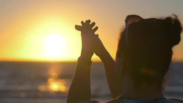 Woman clapping hands at sunset in 4k slow motion 60fps