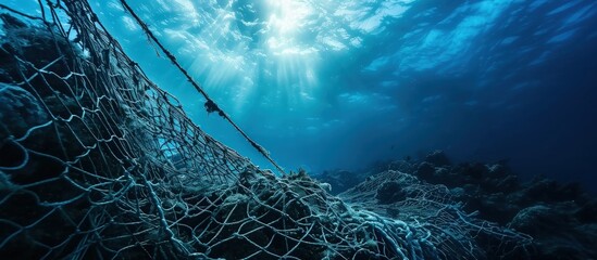 A fishing net underwater fixed on the seabed deep water. Creative Banner. Copyspace image