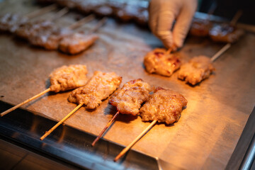 Group of grilled pork skewers are grilling of cooking pan. Thai food object photo.