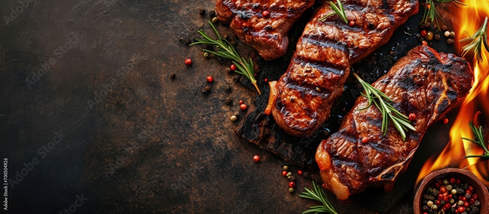 Poster beef steaks on the grill with flames banner menu recipe place for text top view. creative banner. co