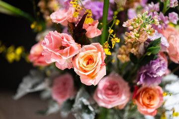 Bunch of colorful pink rose flowers  that arranged with other flower. Close-up and selective focus.