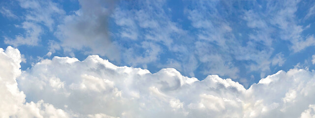 Cloudy sky background banner. Fluffy white clouds panorama.