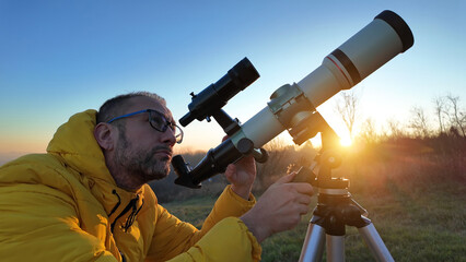 Amateur astronomer observing skies with a telescope.
