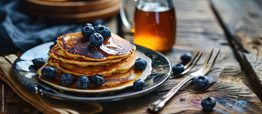 Poster image shows a homemade fluffy pancake with blueberry on the top situation is decorated with rustiv w